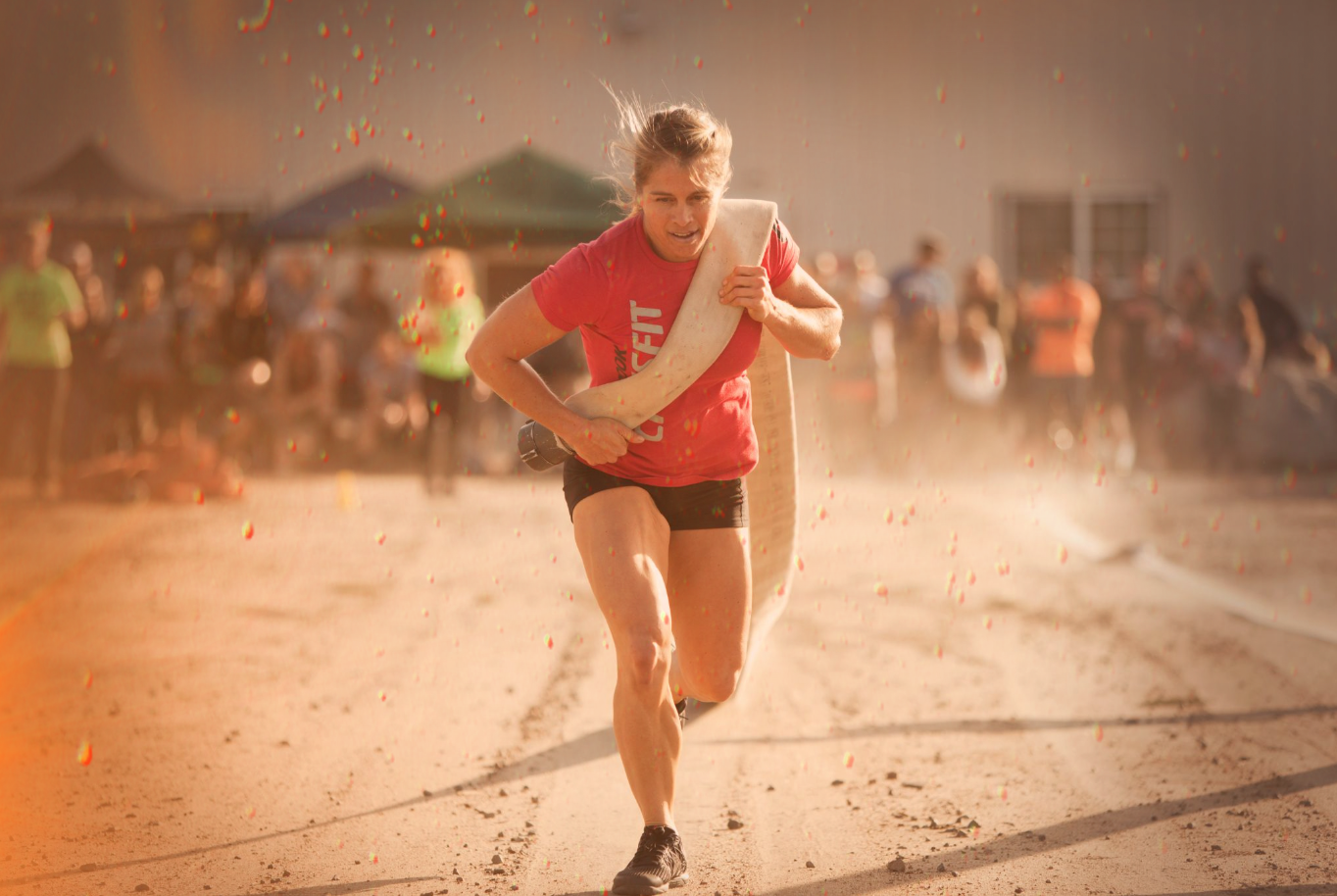 Carrie Sandoval of Fallbrook CrossFit is performing a fire hose drag during a WOD in a local competition held at Driven by CrossFit Temecula South